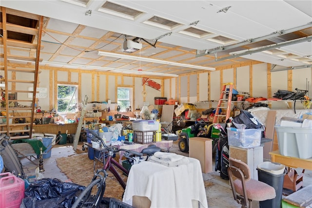 garage with a workshop area and a garage door opener