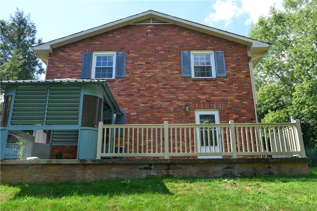 rear view of property featuring a yard