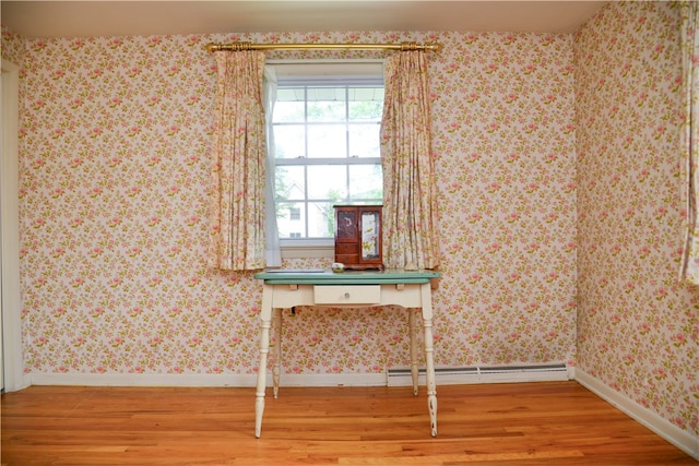 interior space featuring wood-type flooring and a baseboard radiator