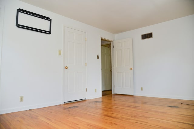 spare room with light hardwood / wood-style floors