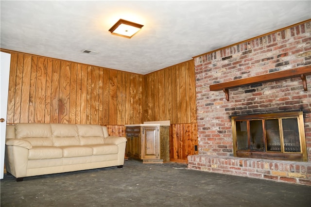 unfurnished living room with wooden walls and a fireplace