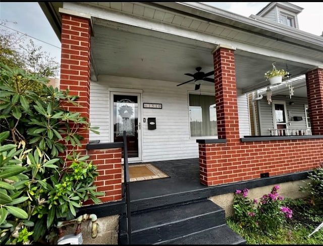 entrance to property with a porch and ceiling fan