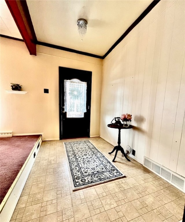 entryway featuring beam ceiling and wooden walls