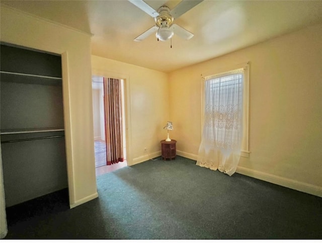 unfurnished bedroom with a closet, ceiling fan, and dark colored carpet