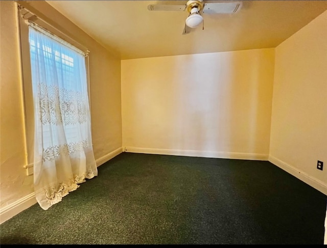 carpeted spare room with ceiling fan