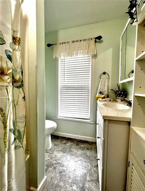 full bathroom with independent shower and bath, toilet, plenty of natural light, and vanity