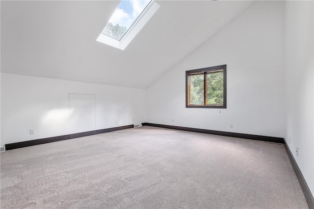 bonus room featuring vaulted ceiling with skylight and carpet floors