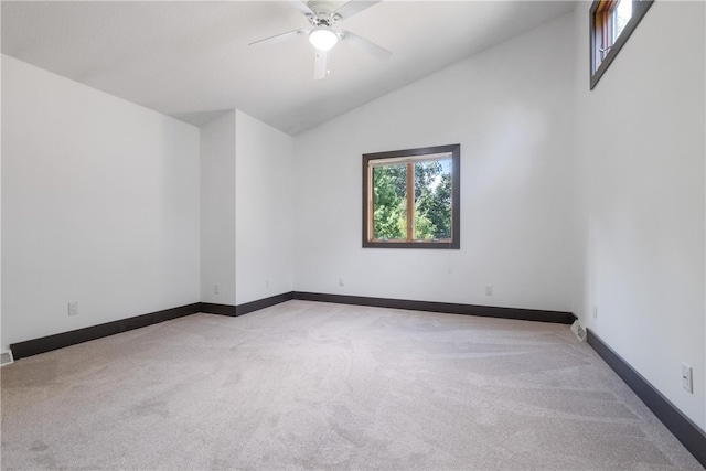 carpeted spare room with lofted ceiling and ceiling fan