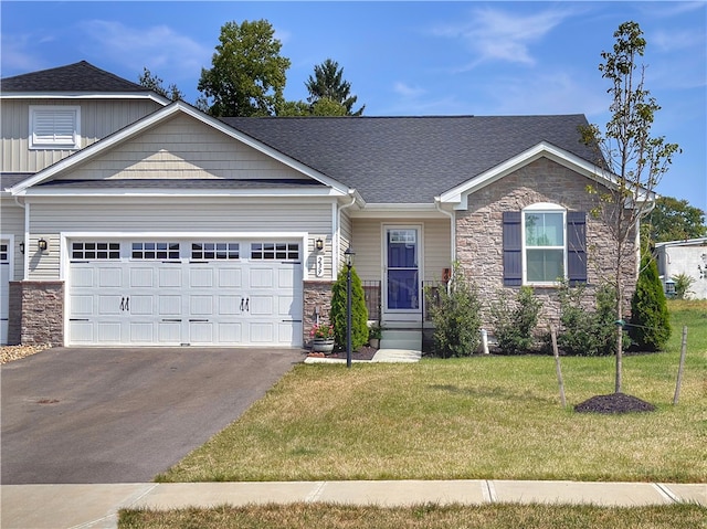 view of front of home with a front yard and a garage