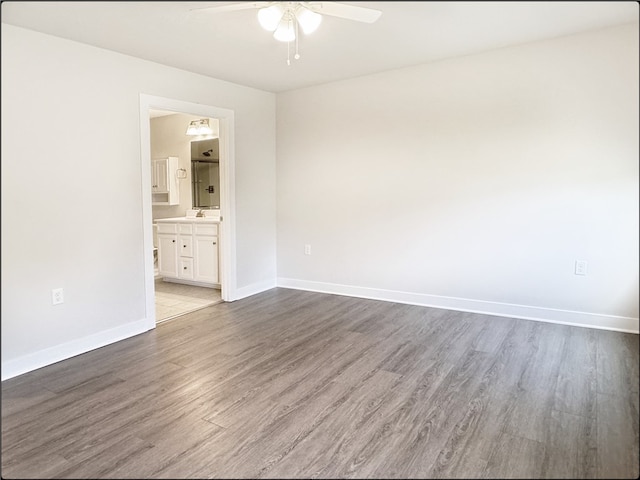 unfurnished room featuring hardwood / wood-style floors and ceiling fan