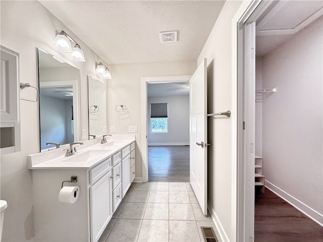 bathroom featuring vanity, a textured ceiling, and hardwood / wood-style flooring