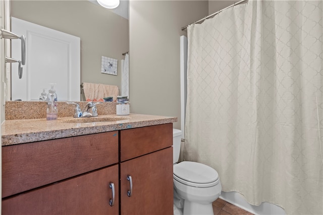 bathroom featuring vanity, toilet, and tile patterned floors