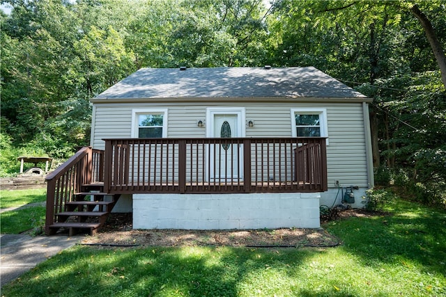 back of house with a yard and a deck