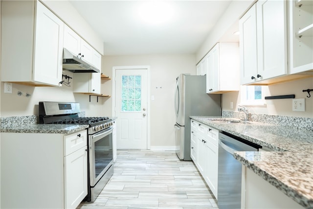 kitchen featuring appliances with stainless steel finishes, plenty of natural light, and white cabinetry