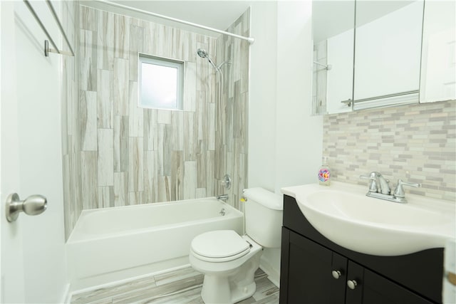 full bathroom with toilet, hardwood / wood-style floors, tiled shower / bath, vanity, and decorative backsplash