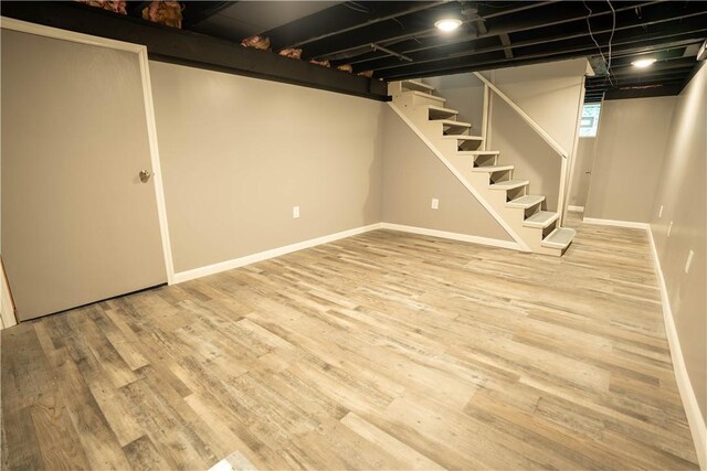 basement with light hardwood / wood-style flooring