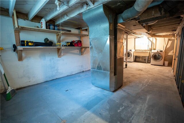 basement with washing machine and dryer and sink