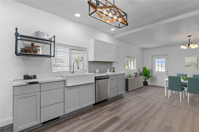 kitchen featuring dishwasher, pendant lighting, sink, and plenty of natural light