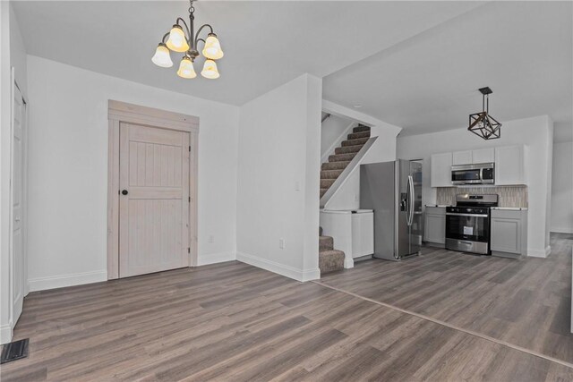 foyer entrance featuring an inviting chandelier and dark hardwood / wood-style floors