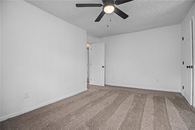 spare room featuring a textured ceiling, carpet floors, and ceiling fan