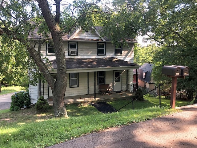 view of front facade featuring a front lawn and a porch