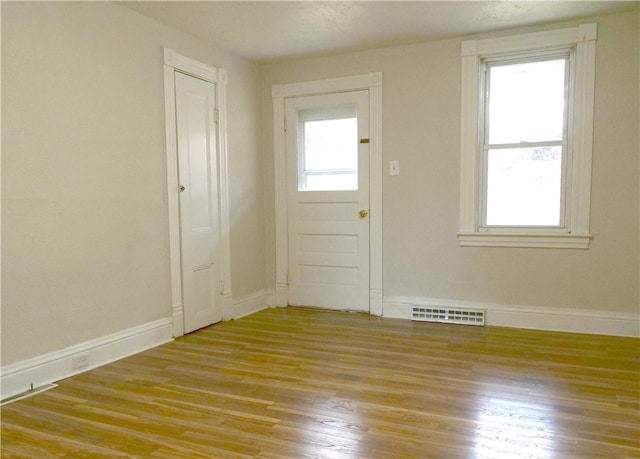 interior space with a wealth of natural light and hardwood / wood-style floors