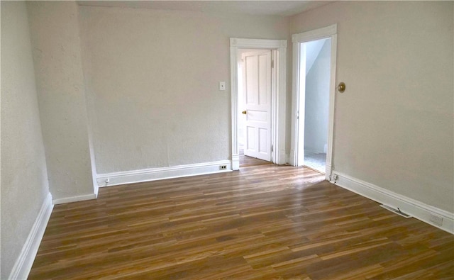 spare room featuring dark hardwood / wood-style floors