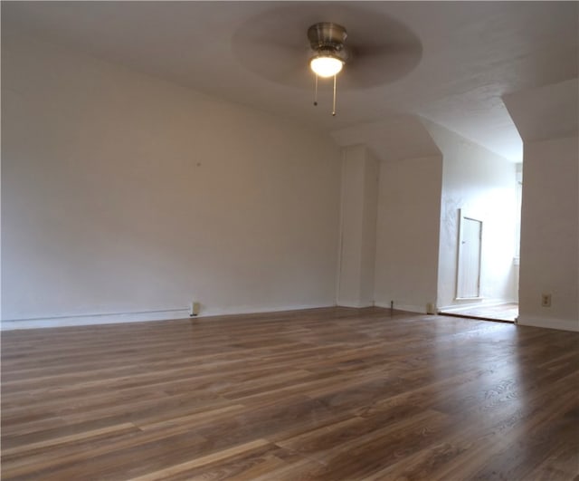 additional living space with dark wood-type flooring and ceiling fan