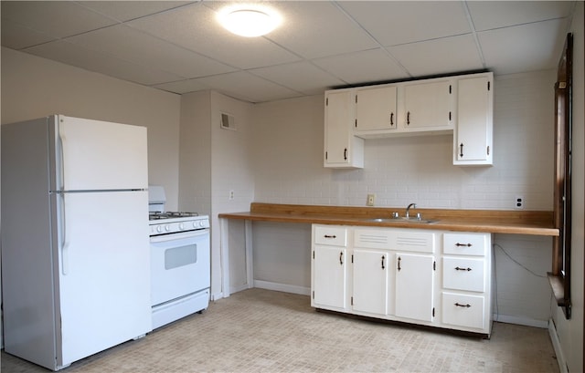 kitchen with white cabinetry, white appliances, backsplash, a paneled ceiling, and sink