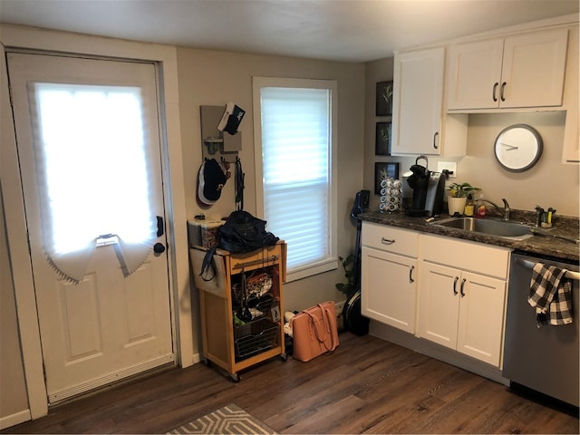 kitchen featuring white cabinets, dishwasher, sink, dark hardwood / wood-style floors, and dark stone counters