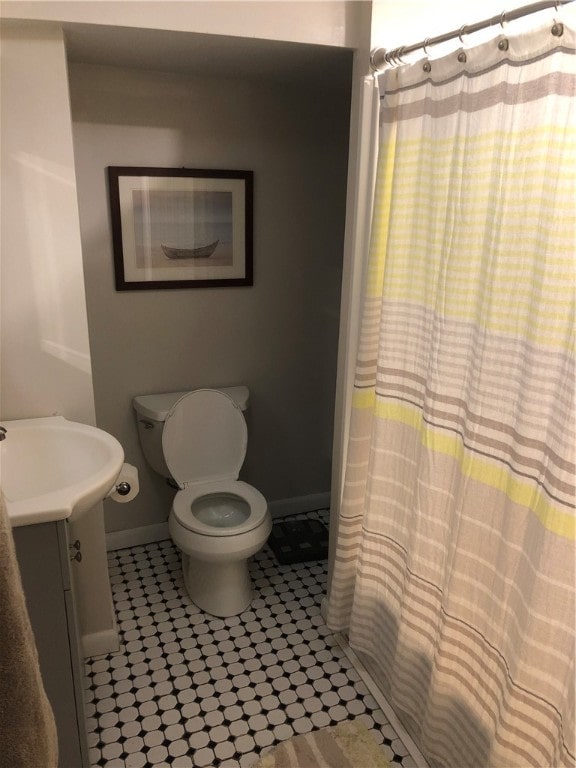 bathroom featuring vanity, toilet, and walk in shower