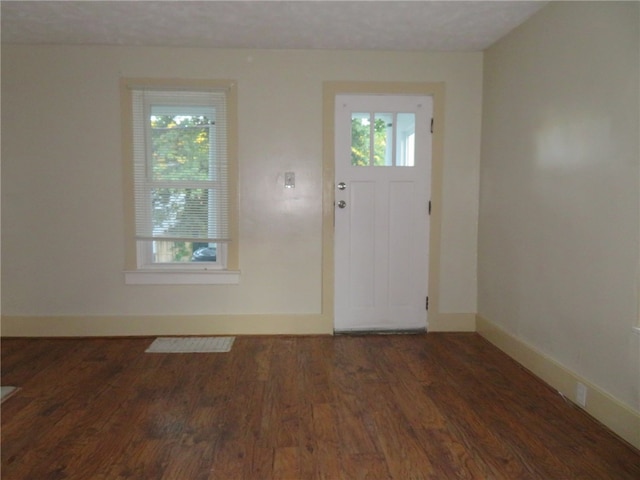 entrance foyer featuring dark wood-type flooring and a textured ceiling