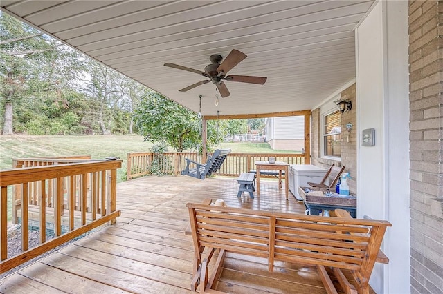 deck featuring ceiling fan and a yard