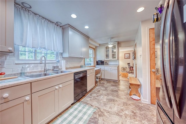 kitchen with stainless steel fridge, tasteful backsplash, ceiling fan, sink, and black dishwasher