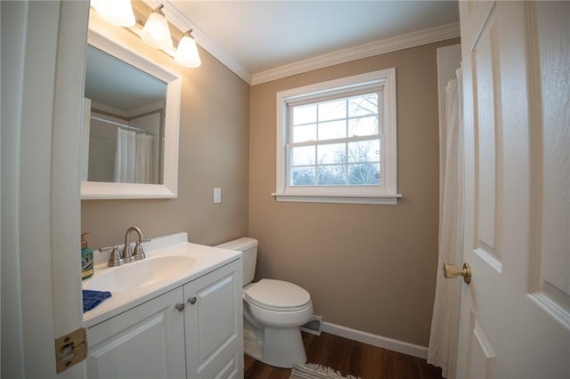 bathroom featuring vanity, toilet, wood-type flooring, and ornamental molding