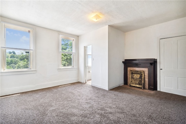 unfurnished living room featuring a textured ceiling and carpet floors