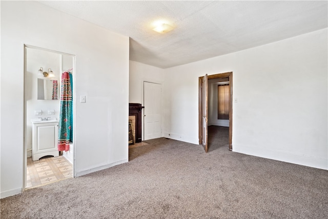 carpeted spare room featuring a textured ceiling