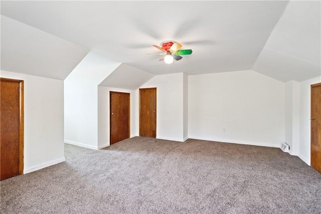 bonus room with vaulted ceiling, ceiling fan, and carpet flooring