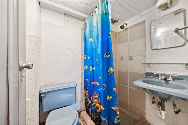 bathroom featuring walk in shower, toilet, and a textured ceiling