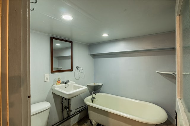 bathroom featuring toilet and a tub