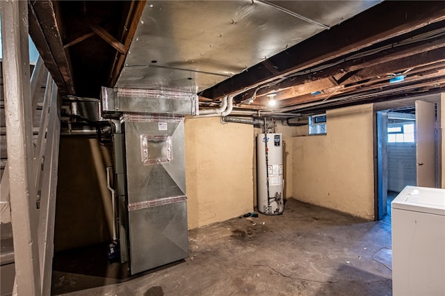 basement featuring gas water heater, washer / dryer, and heating unit