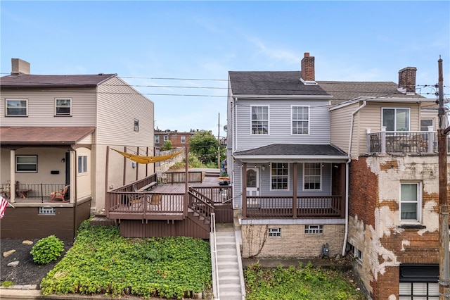 back of property featuring a deck