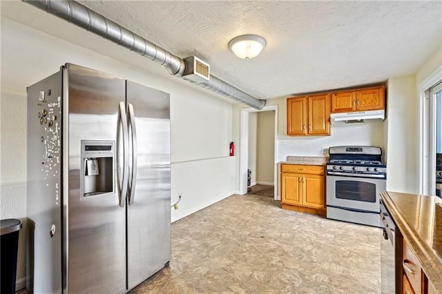 kitchen featuring appliances with stainless steel finishes and a textured ceiling