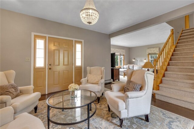 44868 Warner Rd, Pa, PA 16354 - living room with stairs, wood finished floors, baseboard heating, and a chandelier