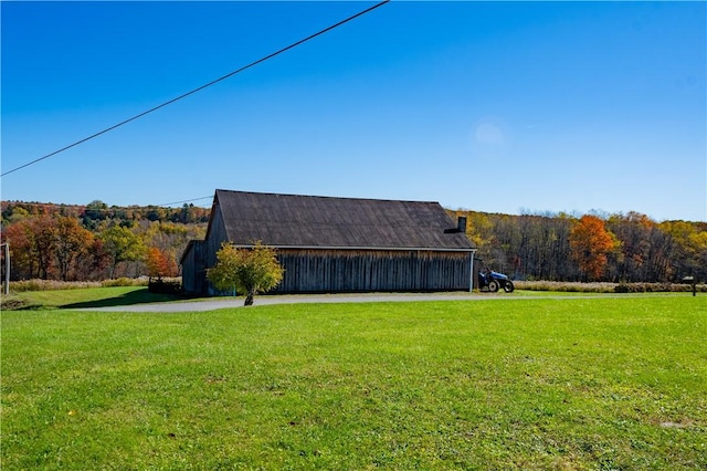44868 Warner Rd, Pa, PA 16354 - view of grassy yard featuring an outbuilding, a wooded view, and a pole building