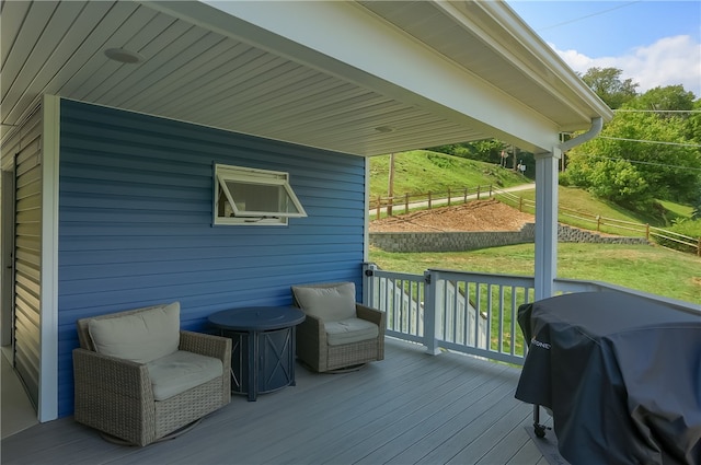 wooden deck with a grill and a yard