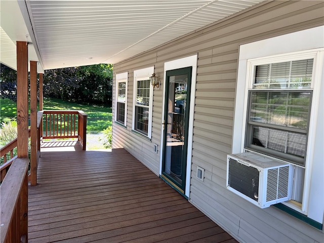 wooden deck featuring cooling unit