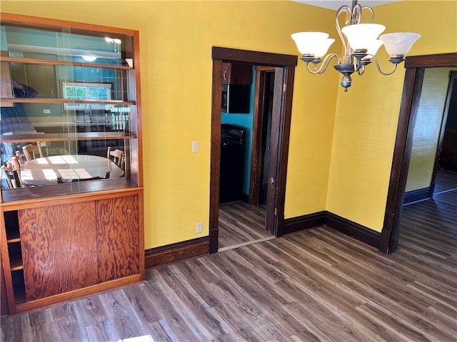 interior space with a chandelier and dark hardwood / wood-style flooring