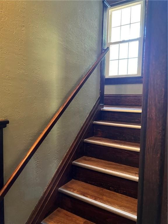 stairs featuring a textured wall