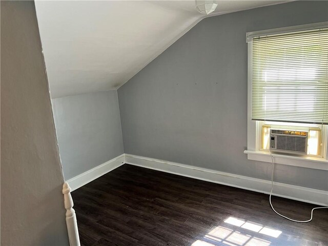 bonus room featuring lofted ceiling, cooling unit, and dark hardwood / wood-style floors